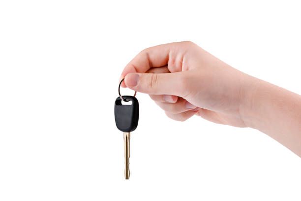 istock human hand.  fingers holding a key .isolate on a white background 1334467662