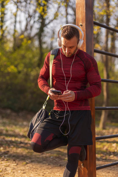 istock Man typing a text message after an outdoor workout 1334467780