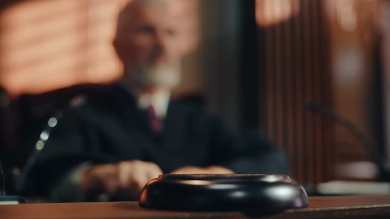 Court of Law and Justice Trial Session: Imparcial Honorable Judge Pronouncing Sentence, striking Gavel. Focus on Mallet, Hammer. Cinematic Shot of Dramatic Not Guilty Verdict. Blurred Slow Motion