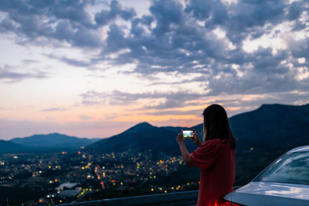 istock Young female traveler using mobile phone outdoors 1334468644