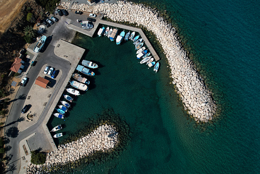 Aerial drone view of fishing boats and tourist yachts moored at the marina. pomos harbor Paphos Cyprus