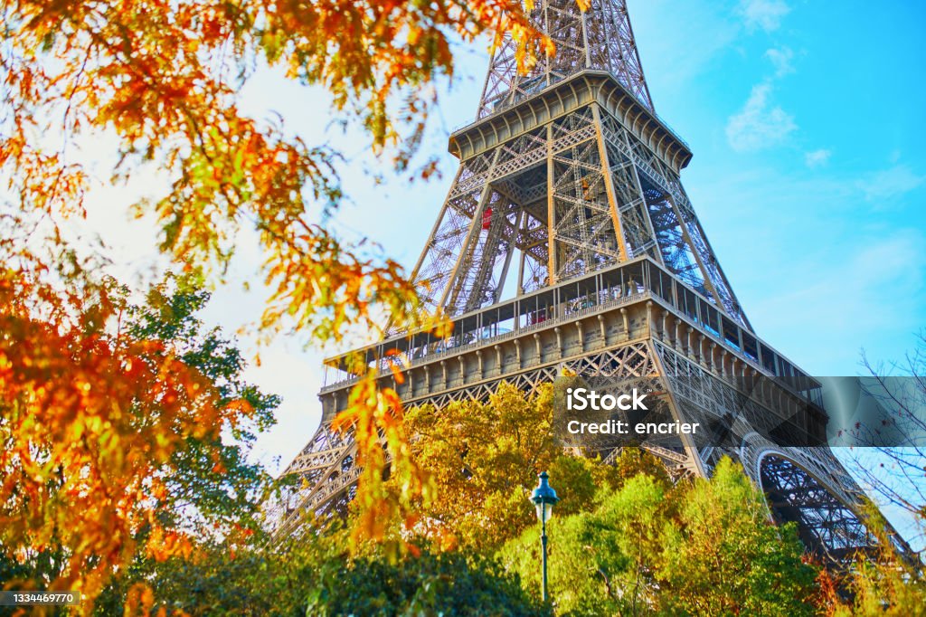 Scenic view of the Eiffel tower and Champ de Mars park on a fall day Scenic view of the Eiffel tower and Champ de Mars park on a beautiful and colorful autumn day October Stock Photo