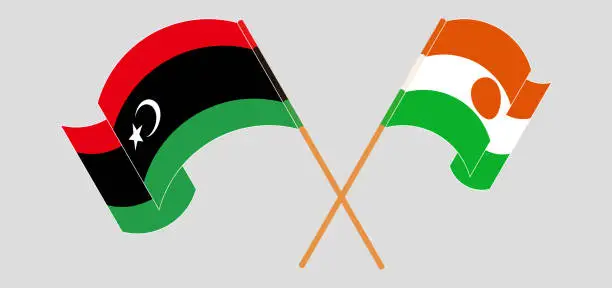 Vector illustration of Crossed and waving flags of Libya and Niger