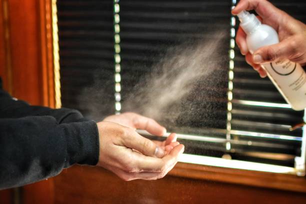 istock Applying alcohol in spray to avoid contagion COVID 1334471086