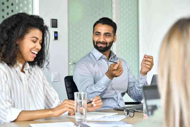istock Smiling Afro American and indian managers discussing project at office meeting. 1334473025