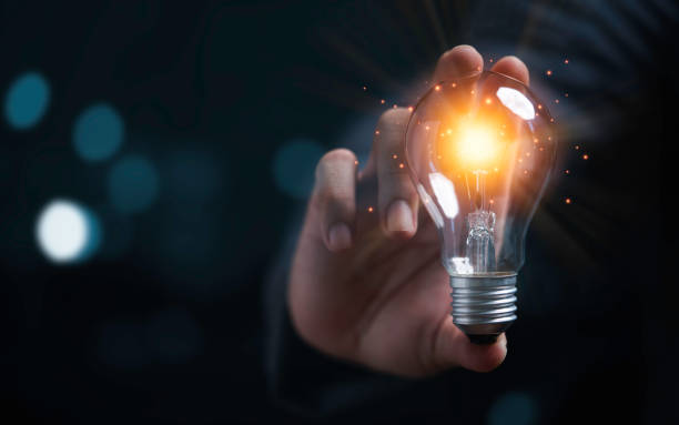 istock Businessman holding glowing light bulb for creative thinking ideas and innovation concept. 1334473053