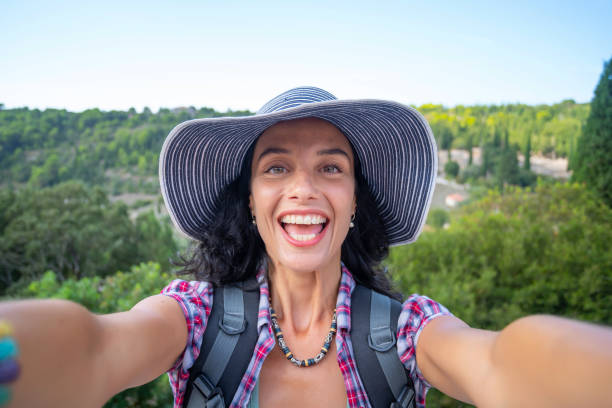 istock Female backpacker relaxing and taking selfie while enjoying summer vacations in Zakynthos Greece 1334473335