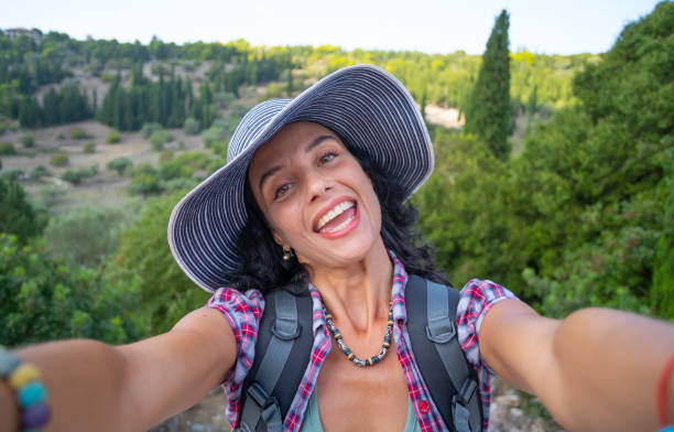 istock Female backpacker relaxing and taking selfie while enjoying summer vacations in Zakynthos Greece 1334473339
