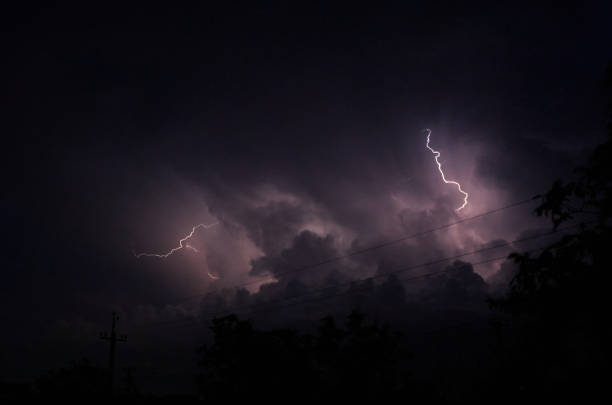 istock Lightning and thunderstorms in the night cloudy sky. Lightning sparkles through the clouds. Night shooting 1334474628