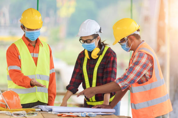Corona or Covid-19 wear masks during the design of construction stock photo