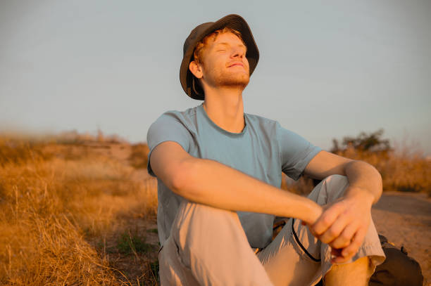 istock A young man sitting and enjoying the sun rays 1334477026