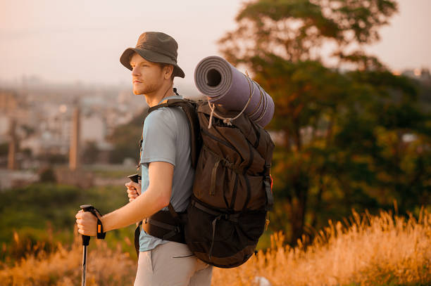 istock A tall man with a backpack standing on the top of the hill 1334477111