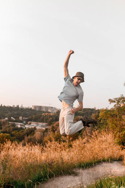 istock A man on the countryside background jumping and feeling excited 1334477169