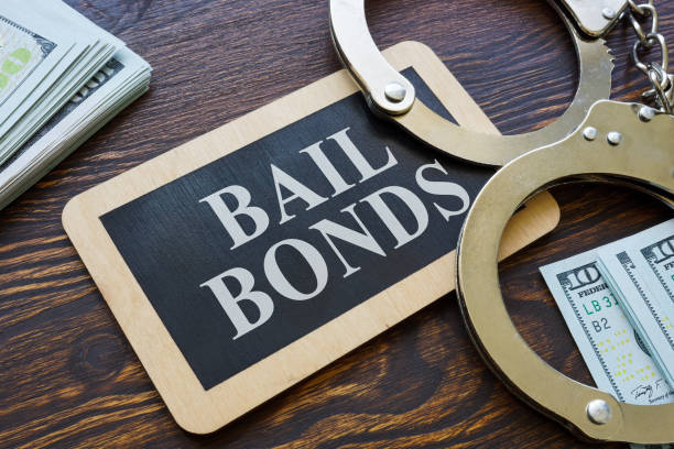 Plate Bail bonds and handcuffs on it. stock photo