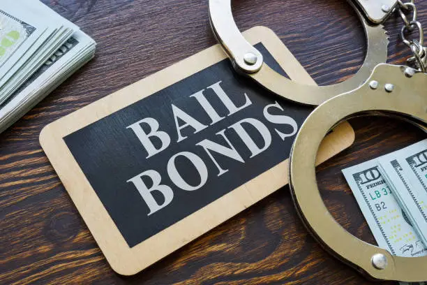 Photo of Plate Bail bonds and handcuffs on it.