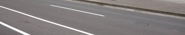 istock Clean road with white lines surface marking and pavement banner 1334478474