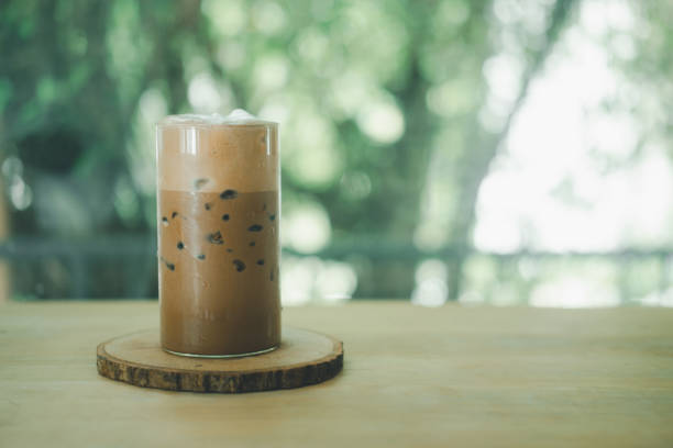 istock Iced  Mocha coffee showing the two layer in a glass on wood table 1334480613