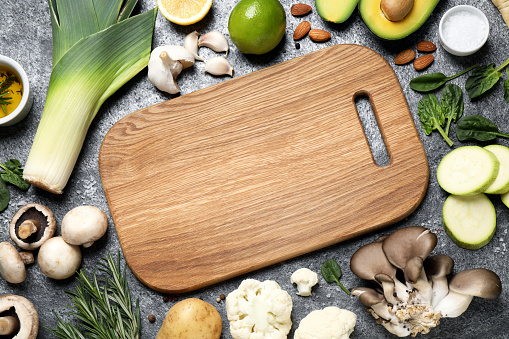 Flat lay composition with fresh products on grey table, space for text. Healthy cooking