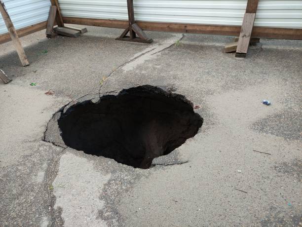 istock Large hole in the asphalt, sinkhole 1334483879