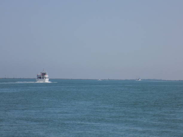 istock A small tourist boat sails towards the coast 1334484264