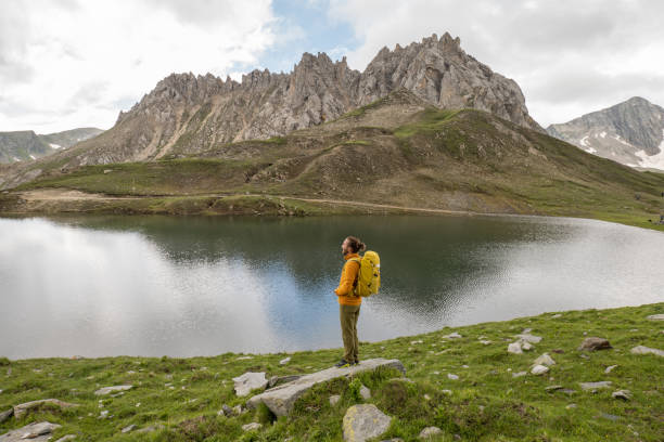 istock Hiker contemplates alpine lake 1334485002