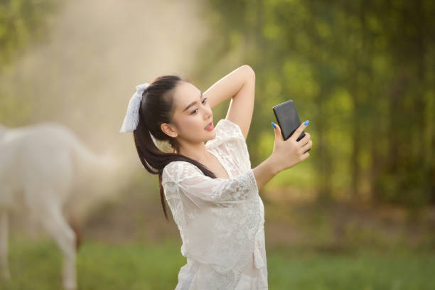 city lifestyle woman with phone outdoor stock photo