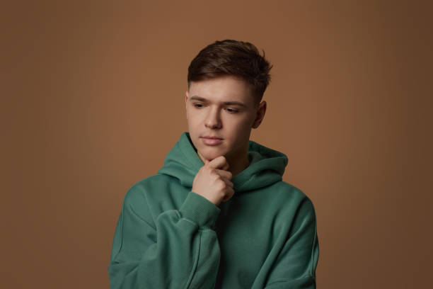 istock young handsome guy touch his chin by hand thinking 1334486167