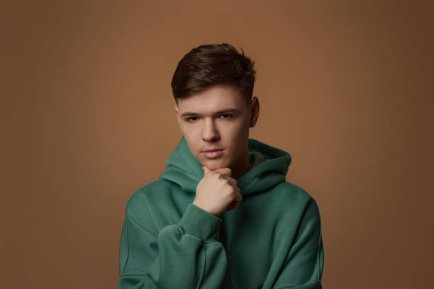 istock young handsome guy touch his chin by hand thinking 1334486180