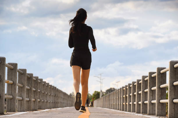 Sporty woman running stock photo