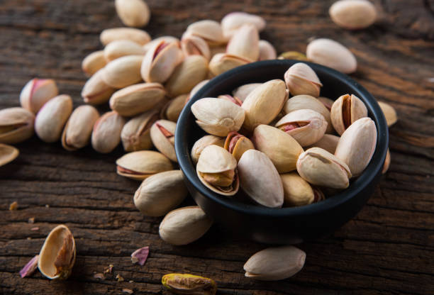 istock Pistachio in a Bowl on Wooden Background 1334486482