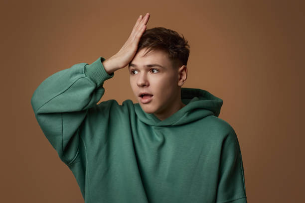 istock upset young guy in sweatshirt forgot something or made a mistake 1334486611