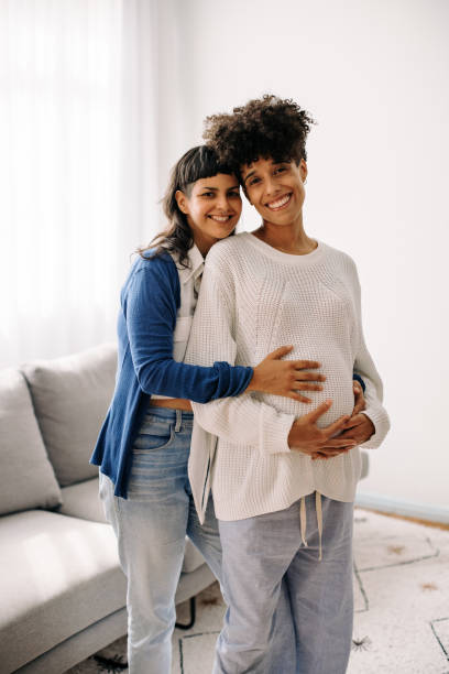istock Expectant lesbian couple smiling at the camera 1334486625