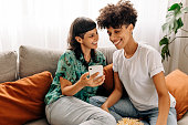 Two lesbian lovers using a smartphone together at home