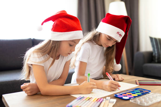 istock Two Beautiful Sisters making Christmas cards. christmas concept background. 1334487682