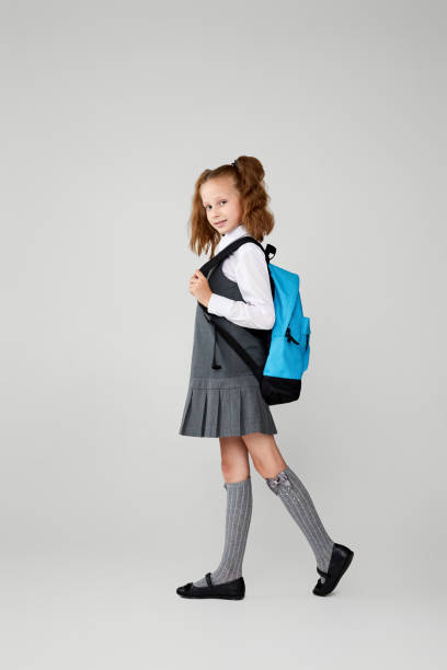 istock adorable schoolgirl with backpack. Back to school 1334489749