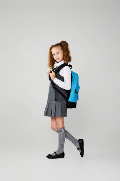 istock adorable schoolgirl with backpack. Back to school 1334489764