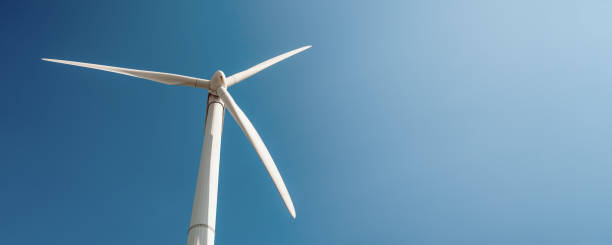 istock Windmill vane generated solar energy against clear blue sky 1334489765