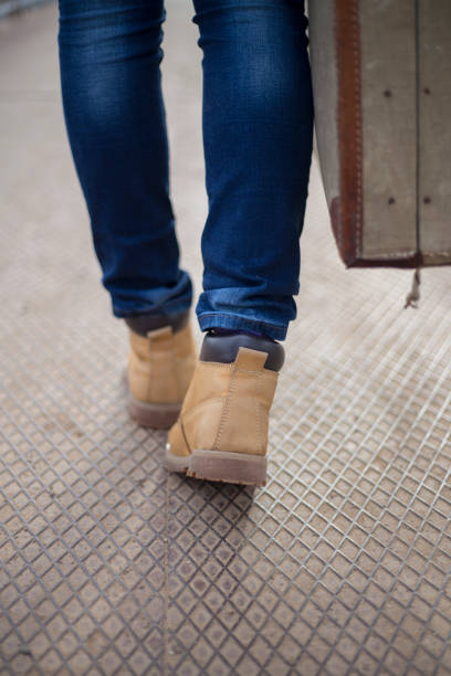 istock Beautiful woman standing on the bridge with suitcase 1334492193