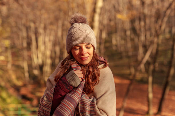 istock Woman relaxing outdoors on sunny autumn day 1334492472