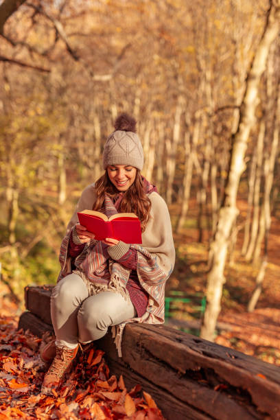 istock Woman reading a book outdoors 1334492918