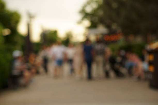 istock Blurred background. A group of people walking in a recreation park. 1334493658