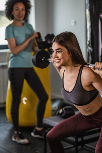 istock Woman in the gym,  doing weightlifting exercise 1334493677