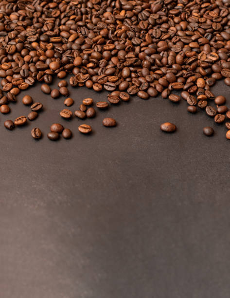 istock Fresh roasted coffee beans on dark background. Selective focus. 1334495465