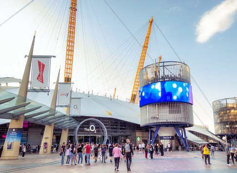 London, UK -People outside the main entrance to the O2 in London. Previously known as the Millennium Dome, the structure houses a variety of food, film, exhibition and music venues.