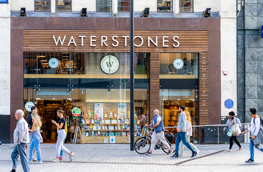 Birmingham, UK - People walking on the pedestrianised street outside the exterior of Waterstones shop in Birmingham's city centre.