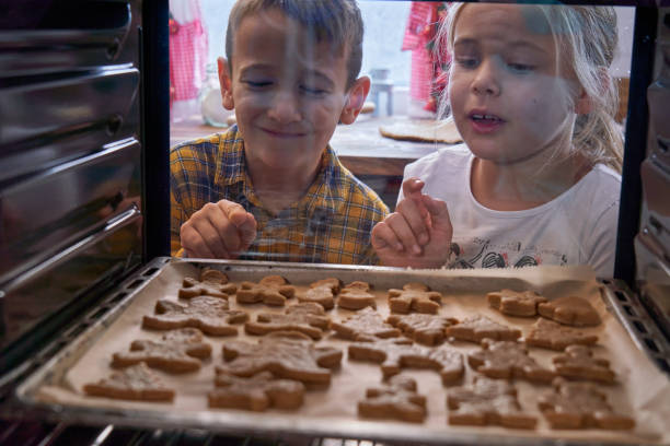 istock Baking Christmas Gingerbread Cookies in the Oven 1334498300