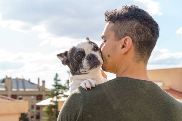 istock Horizontal side view of man loving his dog. 1334498399