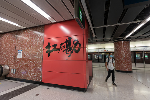 Hong Kong - August 16, 2021 : A man walk past the MTR Hung Hom Station in Hung Hom, Kowloon, Hong Kong. It is the southern terminus of the East Rail line and an intermediate station of Tuen Ma line domestic services of the MTR network.