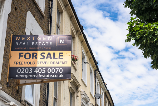London, UK - A Nextgen Real Estate sign advertising a freehold development opportunity on a street in Islington, north London.