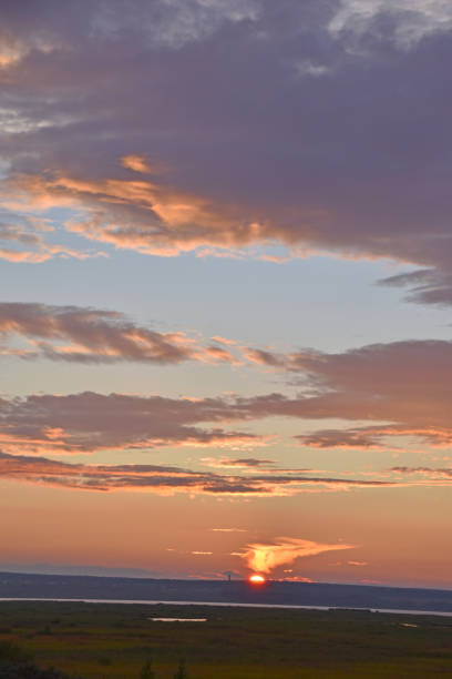 istock Sunset horizon with red clouds in the summer in the field 1334505996